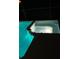 Close-up of a spillover spa attached to the pool with a concrete base at 2505 Osprey Creek Ct, Kissimmee, FL 34747