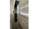 Sleek shower with a multi-setting wall-mounted shower panel and a window for natural light at 2505 Osprey Creek Ct, Kissimmee, FL 34747