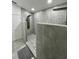 Modern walk-in shower with gray tile, pebble flooring, and dual shower heads at 2505 Osprey Creek Ct, Kissimmee, FL 34747