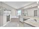 A luxurious bathroom features a glass-enclosed shower, soaking tub, and marble countertops at 2675 Bond St, Clermont, FL 34711