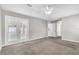 A neutral-toned bedroom features carpet and French doors with access to the back yard at 2675 Bond St, Clermont, FL 34711