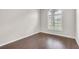 Bright bedroom with hardwood floors and a large arched window, providing natural light at 2675 Bond St, Clermont, FL 34711