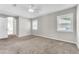 A well-lit bedroom features carpet and two windows with light-filtering blinds at 2675 Bond St, Clermont, FL 34711