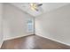Inviting bedroom showcasing sleek wood floors, a modern ceiling fan, and ample natural light at 2675 Bond St, Clermont, FL 34711
