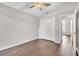 Spacious bedroom featuring wood floors, ceiling fan, and large closet space at 2675 Bond St, Clermont, FL 34711