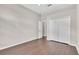 Neutral bedroom featuring wood floors, closet, ceiling fan and trim detail at 2675 Bond St, Clermont, FL 34711