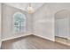 Dining room showcases wood floors, neutral walls, and a chandelier, perfect for intimate gatherings at 2675 Bond St, Clermont, FL 34711