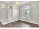 Inviting foyer featuring wood floors, neutral walls, decorative lighting, and a door with sidelight windows at 2675 Bond St, Clermont, FL 34711