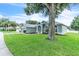 Landscaped front yard showing the home's painted facade, arched windows, and concrete driveway at 2675 Bond St, Clermont, FL 34711