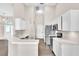 Bright kitchen featuring white cabinets, stainless steel appliances, and modern countertops at 2675 Bond St, Clermont, FL 34711