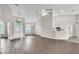 Open-concept living room with vaulted ceilings, wood floors, and views into the kitchen and foyer at 2675 Bond St, Clermont, FL 34711