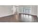 Bright living room featuring wood floors, neutral walls, and glass doors offering access to outdoor spaces at 2675 Bond St, Clermont, FL 34711