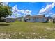 Backyard with a green lawn, gray storage shed, and a glimpse of neighboring houses at 2936 Estill St, Deltona, FL 32738