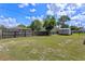 Fenced backyard featuring a lush green lawn and a storage shed at 2936 Estill St, Deltona, FL 32738