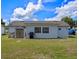 Back view of a home with a spacious backyard, and a small shed at 2936 Estill St, Deltona, FL 32738