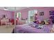 Bright bedroom decorated with pink walls, filled with toys and furniture at 2936 Estill St, Deltona, FL 32738