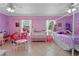 Bright pink bedroom with a canopy bed, pink table and chairs, and a dresser at 2936 Estill St, Deltona, FL 32738