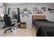 Bedroom features a gaming set up, light tile flooring and decoratively adorned gray walls at 2936 Estill St, Deltona, FL 32738