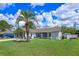 Charming single-story home with a lush green lawn and mature palm tree at 2936 Estill St, Deltona, FL 32738