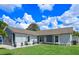 Beautiful single-story home with well-manicured lawn, modern planters, and neutral gray exterior paint at 2936 Estill St, Deltona, FL 32738