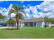 Charming single-story home with a well-manicured lawn and a mature palm tree in the front yard at 2936 Estill St, Deltona, FL 32738