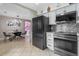 Modern kitchen with gray appliances, white cabinets, and mosaic tile backsplash at 2936 Estill St, Deltona, FL 32738