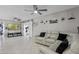 Bright living room featuring tile flooring, neutral walls and comfy furniture, with sliding barn doors at 2936 Estill St, Deltona, FL 32738