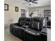 Home theater room featuring tile flooring, an accent wall and large comfy black seating at 2936 Estill St, Deltona, FL 32738
