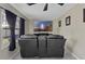 Home theater room featuring tile flooring, an accent wall and large comfy black seating at 2936 Estill St, Deltona, FL 32738