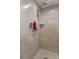 Tiled shower featuring a double shower head and built-in shelving for bath products at 2936 Estill St, Deltona, FL 32738