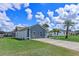 Home exterior with a long driveway, manicured lawn, and well-maintained surroundings at 2936 Estill St, Deltona, FL 32738