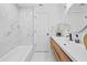 Updated bathroom with marble tile, a modern vanity, and a glass-enclosed tub/shower at 3029 Pinetree, Winter Haven, FL 33884