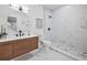 Bathroom featuring a wood vanity, modern fixtures, and a tiled shower with glass door at 3029 Pinetree, Winter Haven, FL 33884