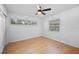 Bright bedroom featuring light wood floors, a ceiling fan, and natural light from the windows at 3029 Pinetree, Winter Haven, FL 33884