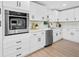 Bright kitchen featuring white cabinets, stainless steel appliances, and quartz countertops at 3029 Pinetree, Winter Haven, FL 33884