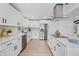 Bright kitchen featuring white cabinets, stainless steel appliances, and quartz countertops at 3029 Pinetree, Winter Haven, FL 33884