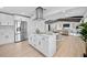 Open concept kitchen featuring an island, stainless steel appliances, and wood flooring at 3029 Pinetree, Winter Haven, FL 33884