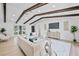 Bright living room featuring wood floors, two sofas, and dark-wood ceiling beams at 3029 Pinetree, Winter Haven, FL 33884