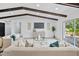 Living room featuring two sofas, a TV, dark-wood ceiling beams, and a glass door to the backyard at 3029 Pinetree, Winter Haven, FL 33884