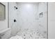 Tiled shower with rainfall showerhead, marble-look tile, and glass enclosure at 3029 Pinetree, Winter Haven, FL 33884