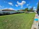 Large backyard with a vast lawn, fruit tree and privacy fence at 306 Aylesbury Ct, Kissimmee, FL 34758