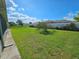 Spacious backyard with a lush lawn and partial fencing for privacy at 306 Aylesbury Ct, Kissimmee, FL 34758
