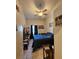 Bedroom with a large blue bed, ceiling fan, tiled flooring, and dark curtains at 306 Aylesbury Ct, Kissimmee, FL 34758
