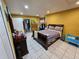 A spacious bedroom with tile flooring and a large bed complemented by ample natural light at 306 Aylesbury Ct, Kissimmee, FL 34758