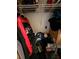 Messy closet with clothes, containers, and miscellaneous stored items at 306 Aylesbury Ct, Kissimmee, FL 34758