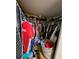 Interior of walk-in closet featuring ample storage with hanging clothes, shelving and other items at 306 Aylesbury Ct, Kissimmee, FL 34758