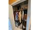 Clothing closet with hanging garments, luggage, and wire shelving at 306 Aylesbury Ct, Kissimmee, FL 34758