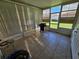 Enclosed patio with neutral tiling and blinds covering large windows at 306 Aylesbury Ct, Kissimmee, FL 34758