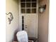 Close up of front door with a chair and decorative hardware at 306 Aylesbury Ct, Kissimmee, FL 34758
