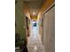 Hallway with white-tiled floor and multiple doors in a home at 306 Aylesbury Ct, Kissimmee, FL 34758